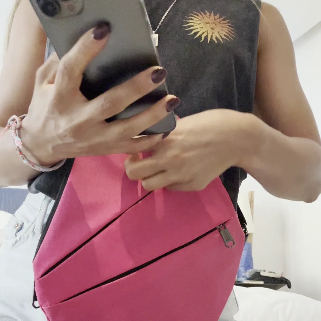 The pink FlyHugz Anti-Theft Bag worn in front