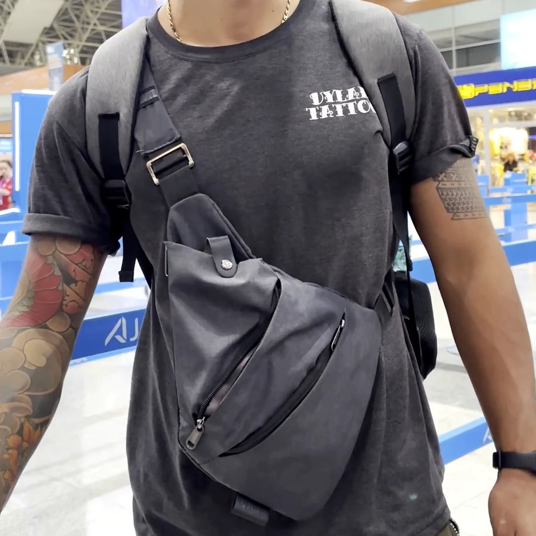 The gray FlyHugz Anti-Theft Bag worn in front at airport check-in